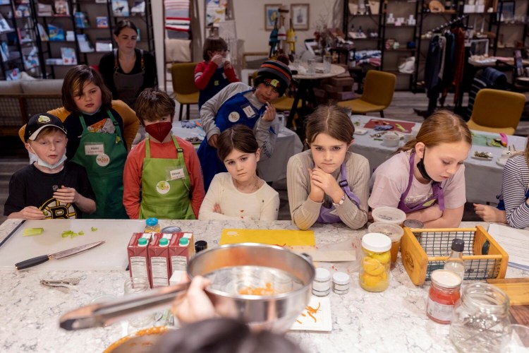 Students in the six-week 4 Kids By Kids cooking course listen to chef Amy Kayne talk about making tomato soup.