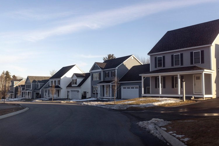 Homes line a street in a development in the village center in North Yarmouth. Voters in town will decide Tuesday whether to sharply limit the number of permits for new housing in the village center.