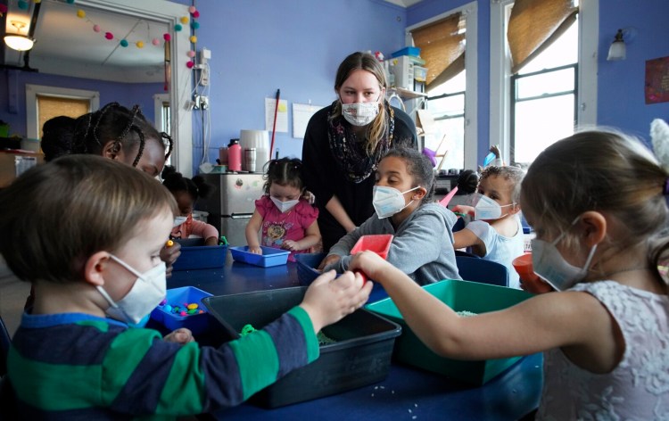 Teacher Liz Pierce talks to children in a preschool classroom at the Youth and Family Outreach daycare center in Portland on Friday. A proposed bill would help daycare centers recruit and retain staff at the state's daycare centers. 