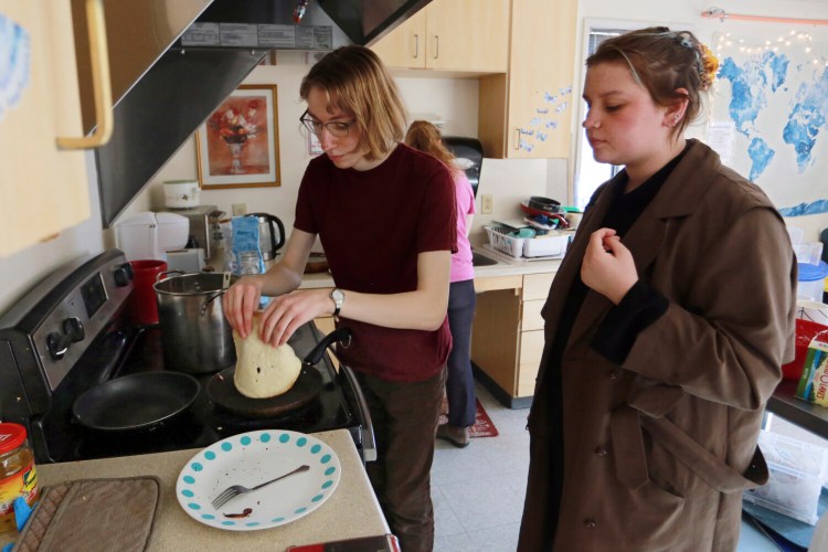 Students Sophia Pavlenko, left, of Russia, and Masha Novikova, of Ukraine, prepare blini, the Eastern European-style crepes, to sell to fellow students in a dorm Sunday at the United World College in Montezuma, N.M. 