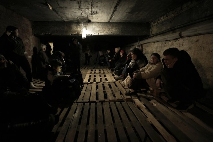 People shelter underground following explosions in Lviv, western Ukraine, on Saturday.