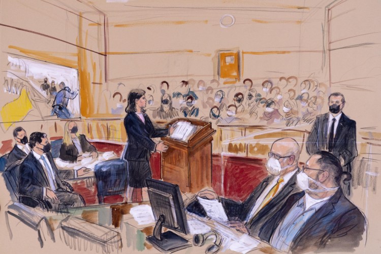 This artist's sketch depicts Guy Wesley Reffitt, bottom right, joined by his lawyer William Welch, third from right, listening as prosecutor Risa Berkower, speaks at the podium at center, as a video depicts a handgun on the waist of Reffitt, on screen at left, for members of the jury and audience in Federal Court, in Washington on Monday. 