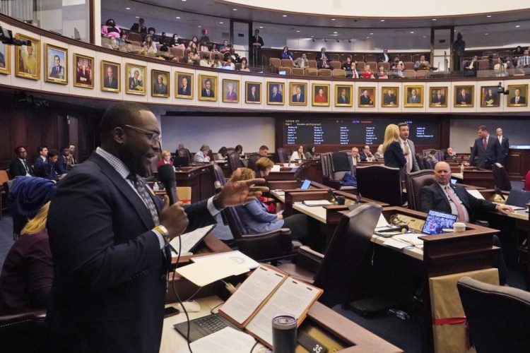 Florida Sen. Shevrin Jones, left, speaks about his proposed amendment to a bill, dubbed by opponents as the "Don't Say Gay" bill, at the Florida State Capitol on Monday in Tallahassee. The legislation was passed Tuesday and is expected to be signed quickly by Gov. Ron DeSantis.