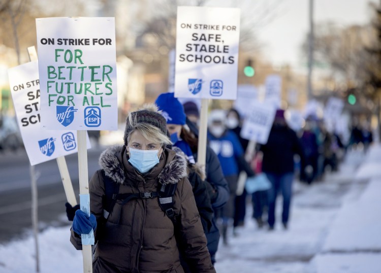 Minneapolis teachers and supporters picket on Tuesday. A main union demand is a starting salary of $35,000 for education support professionals, compared with the current $24,000.   