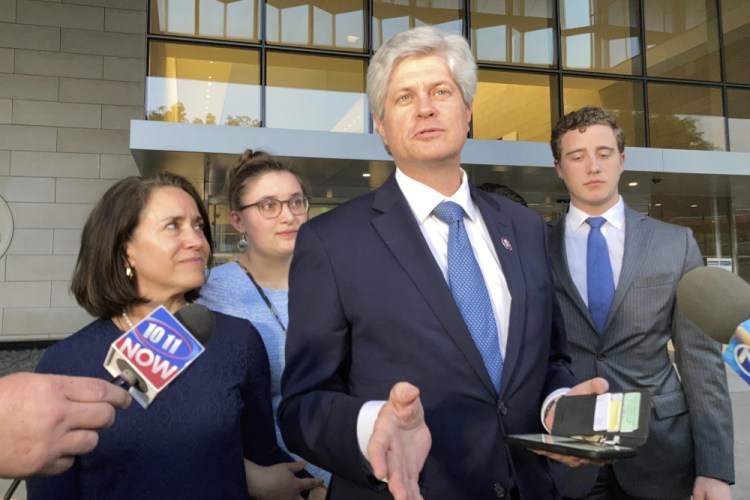 U.S. Rep. Jeff Fortenberry, R-Neb., center, speaks with the media outside the federal courthouse Thursday in Los Angeles.
