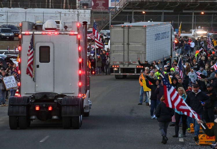 Supporters cheer as the self-styled "Freedom Convoy" arrives at the Hagerstown Speedway in Maryland on Friday. 