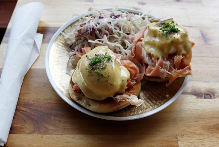 The Benedictino, made with jamon serrano, smoked piquante, poached eggs and cabbage salad at Cafe Louis. 