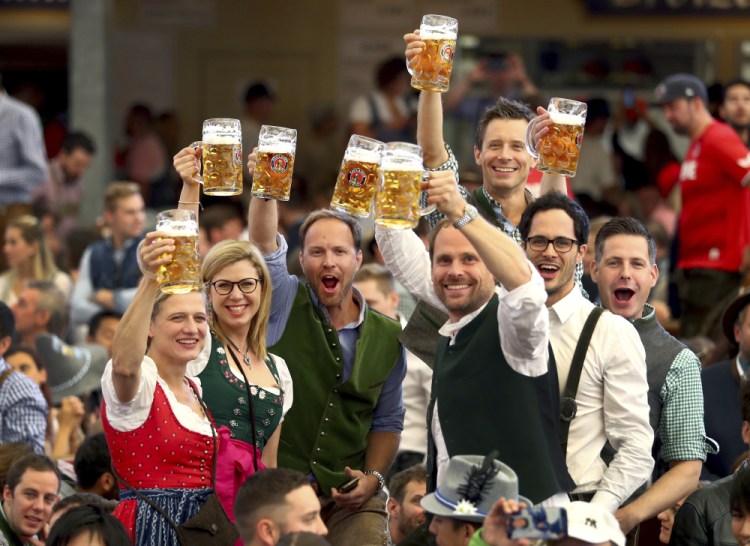Visitors lift glasses during the opening of the 186th Oktoberfest beer festival in Munich, Germany, in 2019. 