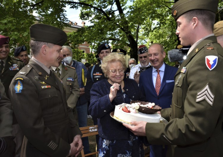 Soldiers from U.S. Army Garrison Italy present a birthday cake to Meri Mion in Vicenza on Thursday