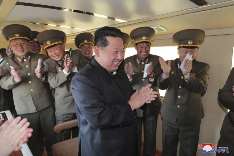 North Korean leader Kim Jong Un celebrates with military officers after the successful launch of a new guided weapon, the Korean Central News Agency reported Sunday. 