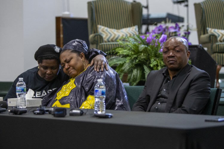 From left, Dorothy Sewe consoles Patrick Lyoya's mother, Dorcas, near Lyoya's father, Peter, during a news conference at the Renaissance Church of God in Christ Family Life Center in Grand Rapids, Mich. on Thursday.