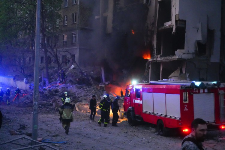 Firefighters put out a fire after a Russian rocket attack in Kyiv, Ukraine, on Thursday. Russia mounted attacks across a wide area of Ukraine on Thursday, bombarding Kyiv during a visit by the head of the United Nations. Efrem Lukatsky/Associated Press