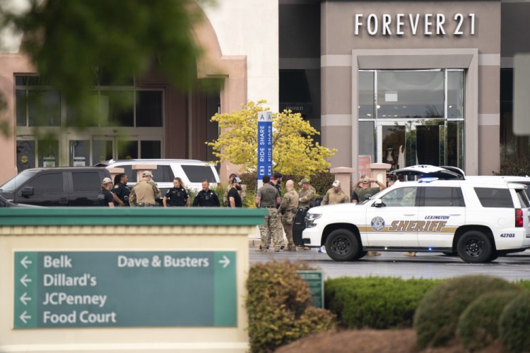 Members of law enforcement gather outside Columbiana Centre mall in Columbia, S.C., following a shooting, Saturday.