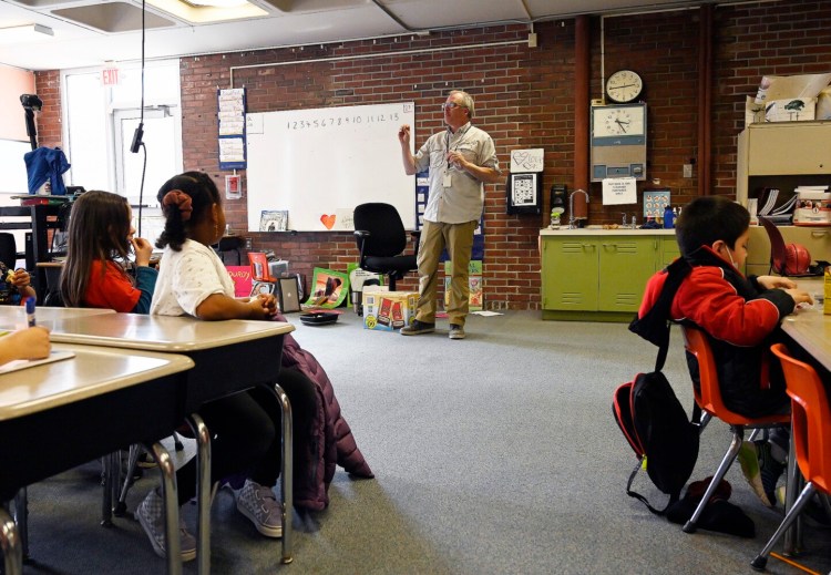 Kindergarten teacher Kevin Brewster talks with his class Friday in one of the older classrooms at Reiche Elementary School in Portland.
