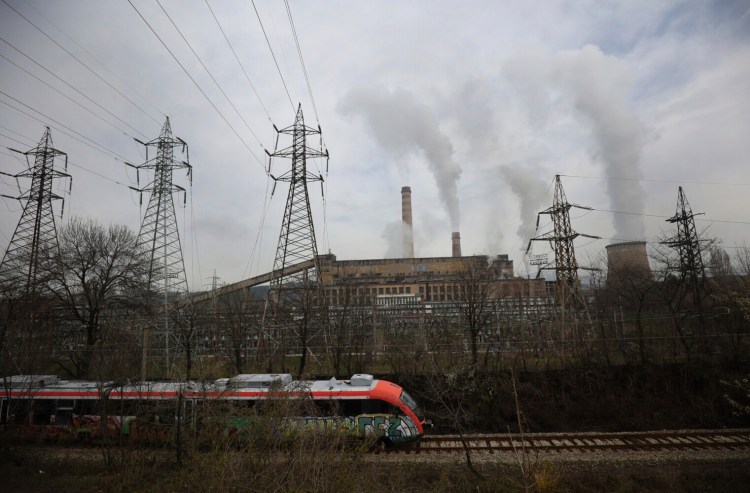 A train passes by Republika Power Plant in town of Pernik, Bulgaria, Thursday, April 21, 2022. The only nuclear power plant, generating over a third of Bulgaria’s electricity, runs on uranium from Russia. (AP Photo/Valentina Petrova)