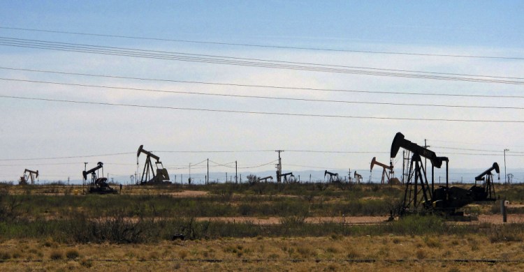 Oil rigs stand in the Loco Hills field along U.S. Highway 82 near Artesia, N.M. Soaring fossil fuel industry profits have allowed the state Legislature to try to tackle the highest-in-the-nation unemployment rate and persistently high poverty. While Gov. Michelle Lujan Grisham has called for new mandates clean energy sources, she has cautioned the federal government against significant restrictions on oil exploration and production, the state budget's lifeblood.