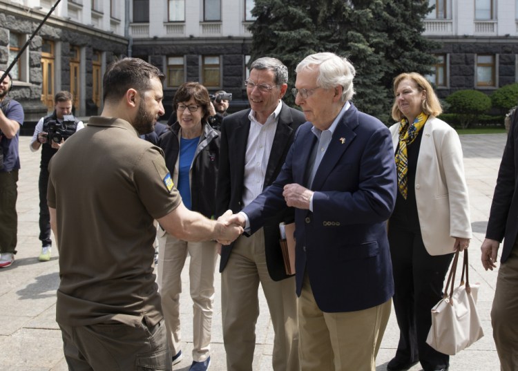 Ukrainian President Volodymyr Zelensky, left, shakes hands with Senate Minority Leader Mitch McConnell, R-Ky., in Kyiv, Ukraine, on Saturday. Maine Sen. Susan Collins stands behind them.
