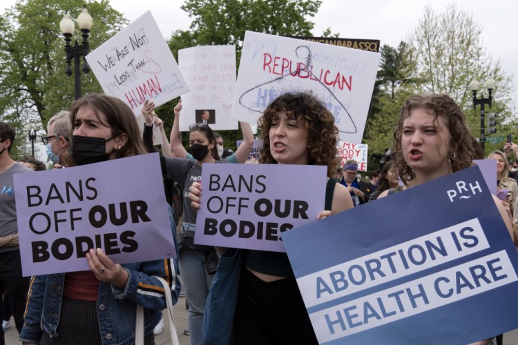 Demonstrators protest outside of the  Supreme Court on Tuesday. As written, the ruling would give states the power to decide the legality of abortion. Roughly half, largely in the South and Midwest, would likely quickly ban abortion.
