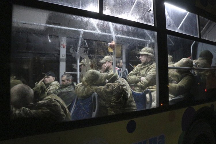 Ukrainian servicemen sit on a bus after leaving Mariupol's besieged Azovstal steel plant, near a penal colony, in Olyonivka, in territory under the government of the Donetsk People's Republic, eastern Ukraine, on Friday.