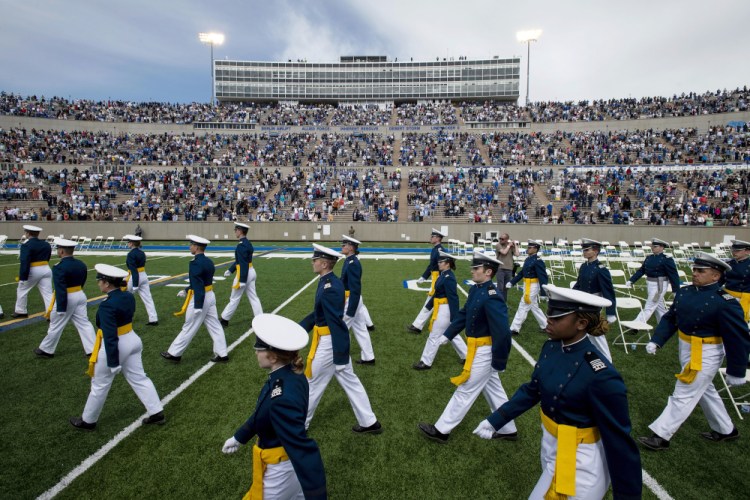 Air Force Academy cadets make their way to their seats  during the Air Force Academy's Class of 2021 graduation ceremony  in Colorado Springs, Colo., last year. Four cadets at the Air Force Academy may not graduate or be commissioned as military officers this because they have refused the COVID-19 vaccine. 