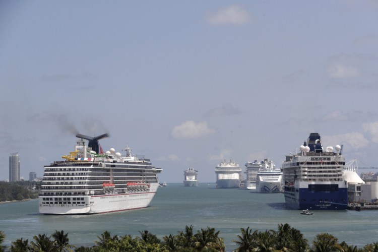 Cruise ships float at PortMiami in April 2020. Beginning next year, all large ships will be assigned a Carbon Intensity Indicator –  worked out by dividing carbon dioxide output by the capacity of the ship and again by nautical miles traveled – which then gives ships an A to E sustainability rating. 