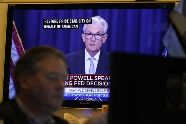 Federal Reserve Chairman Jerome Powell is displayed on televisions while traders work on the floor Wednesday at the New York Stock Exchange in New York.