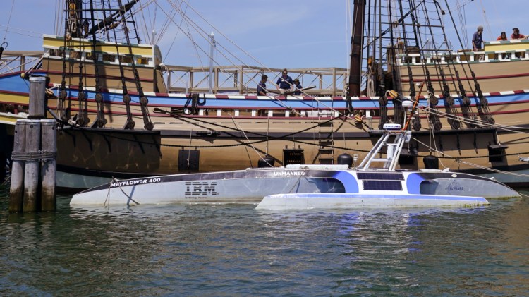 Mayflower Autonomous Ship floats next to the replica of the original Mayflower on Thursday in Plymouth, Mass. The crewless robotic boat retraced the 1620 sea voyage of the Mayflower.