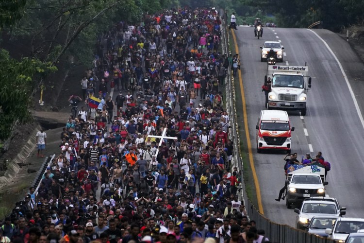 Migrants, many from Central America and Venezuela, walk along the Huehuetan highway on Tuesday in Chiapas state, Mexico.