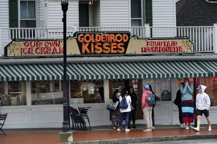 High school students gather outside The Goldenrod, a popular restaurant and candy shop in York Beach on Wednesday.