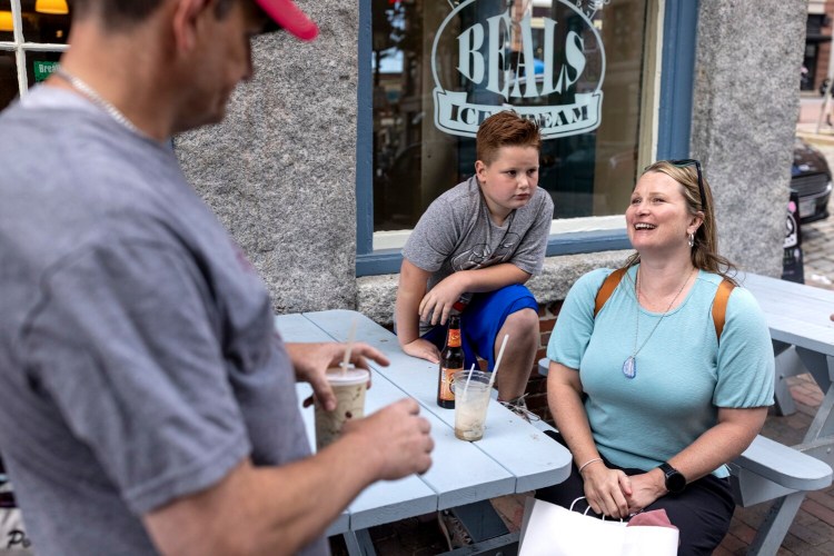 Jen Smith, of Bethel Park, Pennsylvania, sits next to her son Deklan Smith, 8, taking a break from sightseeing in the Old Port in late June. Smith had been to Portland for work once and thought "it was the cutest town and the lobster was fantastic" so she wanted to bring her whole family. 