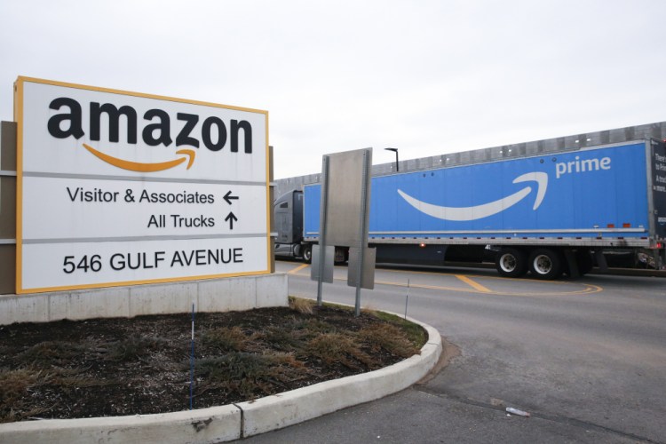 An Amazon Prime truck passes by a fulfillment center on Staten Island, New York. CEO Andy Jassy said in May the company is going to let some of its warehouse leases expire and defer construction on others. Amazon is also subleasing warehouses to cut costs. 
