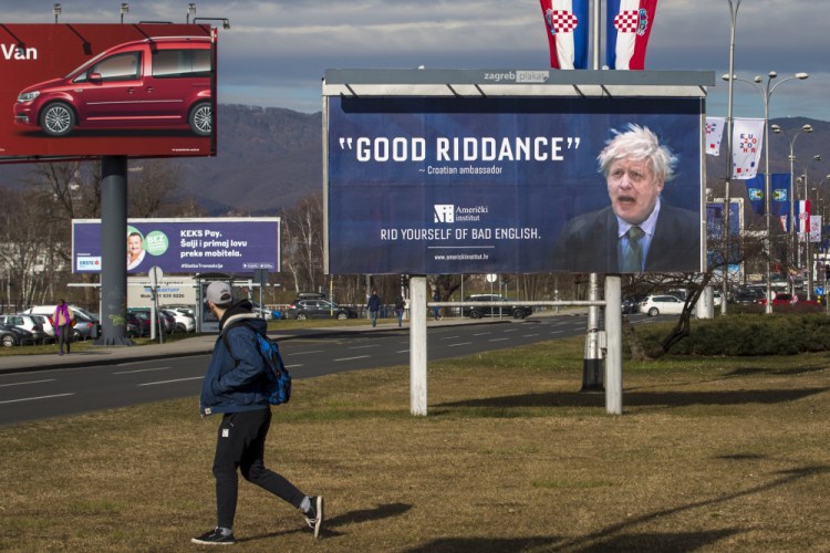 A passer-by checks out a billboard advertising an English language school in Zagreb, Croatia, in 2020. Outgoing U.K. Prime Minister Boris Johnson has been the bane of Brussels for many years, from his days stoking anti-European Union sentiment with exaggerated newspaper stories to his populist campaign leading Britain out of the bloc and reneging on the post-Brexit trade deal he himself signed.