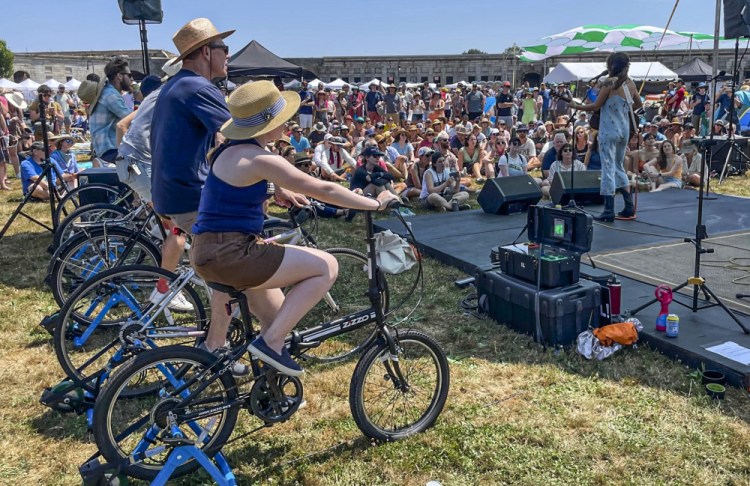 Madi Diaz performs on the Newport Folk Festival's bike stage, powered in part by festivalgoers on stationary bicycles, Friday in Newport, R.I. 