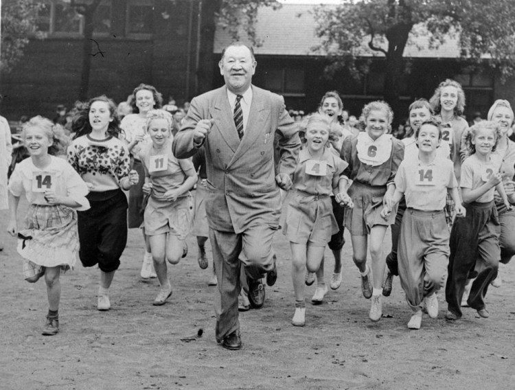 Big Jim Thorpe sets a fast pace for some girls during a "junior olympics" event on Chicago's south side in 1948.