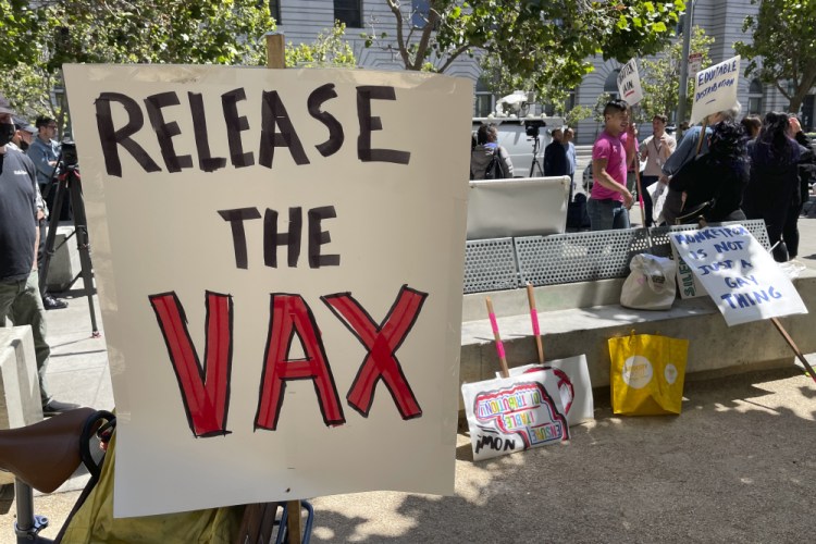 A sign urges the release of the monkeypox vaccine during a protest in San Francisco. The mayor of San Francisco announced a legal state of emergency Thursday over the growing number of monkeypox cases.  
