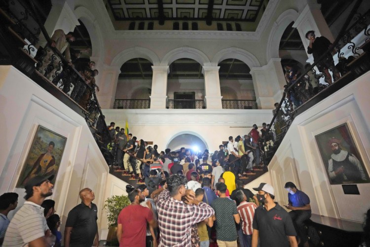 Protesters storm into the Sri Lankan president's official residence, in Colombo, Sri Lanka, on Saturday. 