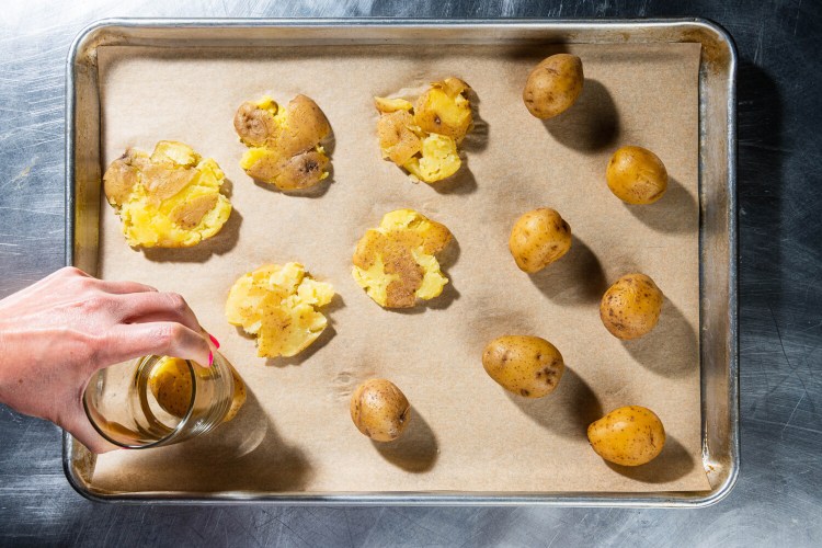 Use the bottom of a water glass to flatten the potatoes so you don't touch the hot potatoes with your hands.