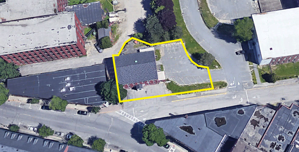 Building 30 and parking lot, Pepperell Mill. Listed for sale in June 2022.