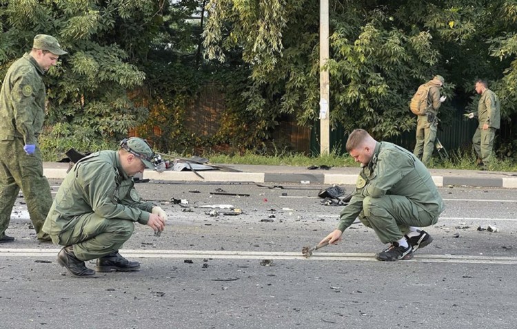 Investigators work at the site of an explosion that killed Daria Dugina outside Moscow. Dugina is the daughter of Alexander Dugin, the Russian nationalist ideologist often called "Putin's brain."