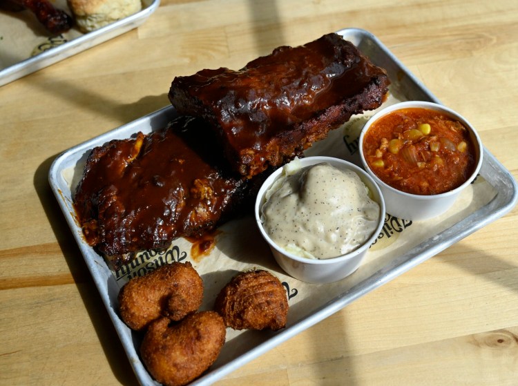 Baby Back Ribs served with hushpuppies, mashed potatoes with gravy and Brunswick stew at Wilson County Barbecue.