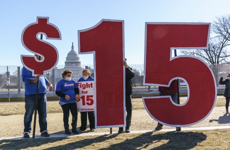 Activists appeal for a $15 minimum wage near the Capitol in Washington on Feb. 25, 2021. A new poll found Democrats were more likely than Republicans to say that factors such as parents’ wealth, the community one lives in, college education, race  and gender greatly affect one’s social mobility.