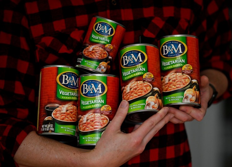 Rob Foster of Portland  holds his stash of older B&M Baked Beans, which he plans to ration over time. 