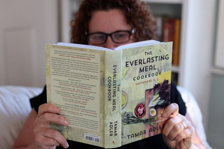 Christine Burns Rudalevige poses with her new favorite book, "The Everlasting Meal Cookbook: Leftovers A-Z" by Tamar Adler. 