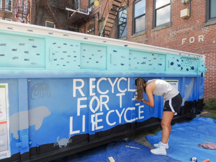 People can paint recycling dumpsters at Ecomaine's Earth Day event in North Yarmouth on Saturday. 