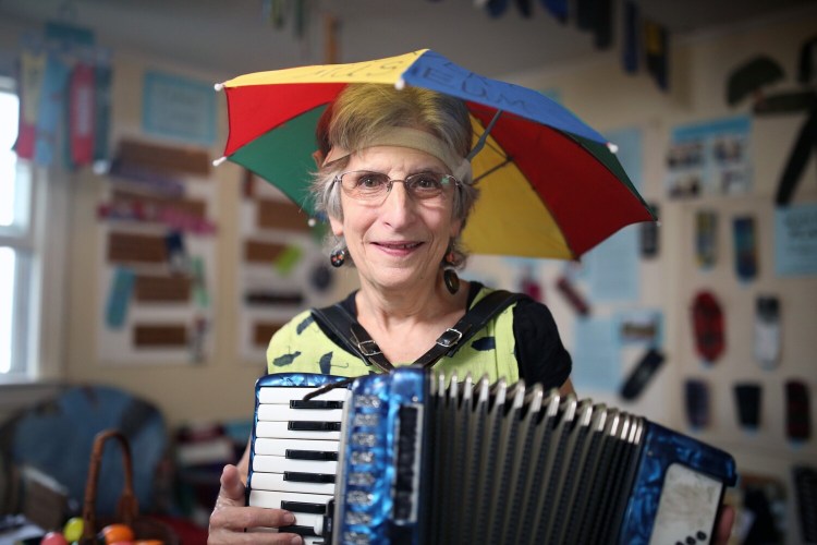 Nancy 3. Hoffman plays accordion for visitors at her Umbrella Cover Museum on Peaks Island, which opens for the season May 27. 