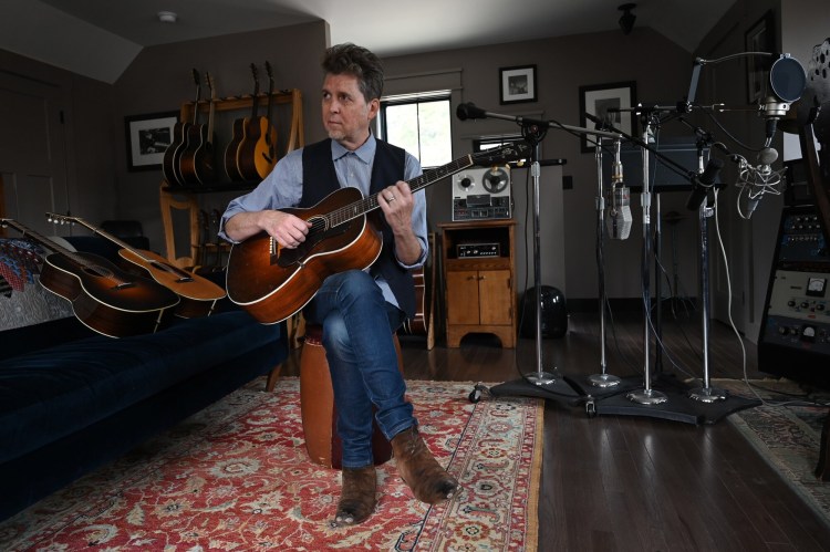 Singer and songwriter Joe Henry plays his 1931 Gibson Nick Lucas Special guitar at his home in Harpswell. 