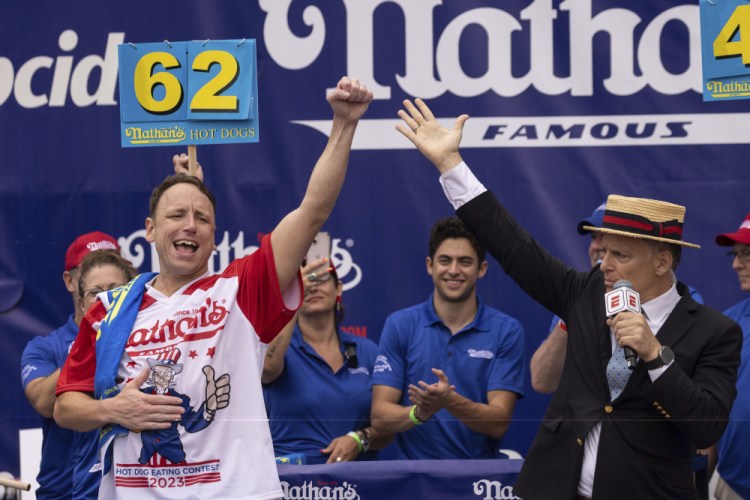Joey Chestnut celebrates Tuesday after winning his 16th championship title at the Nathan's Famous Fourth of July hot dog eating contest. Yuki Iwamura/Associated Press