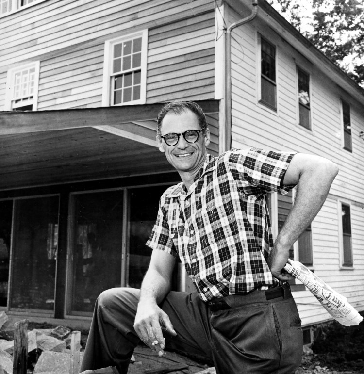 Playwright Arthur Miller poses in front of his farmhouse in Roxbury, Conn., on Aug. 7, 1958.  Associated Press