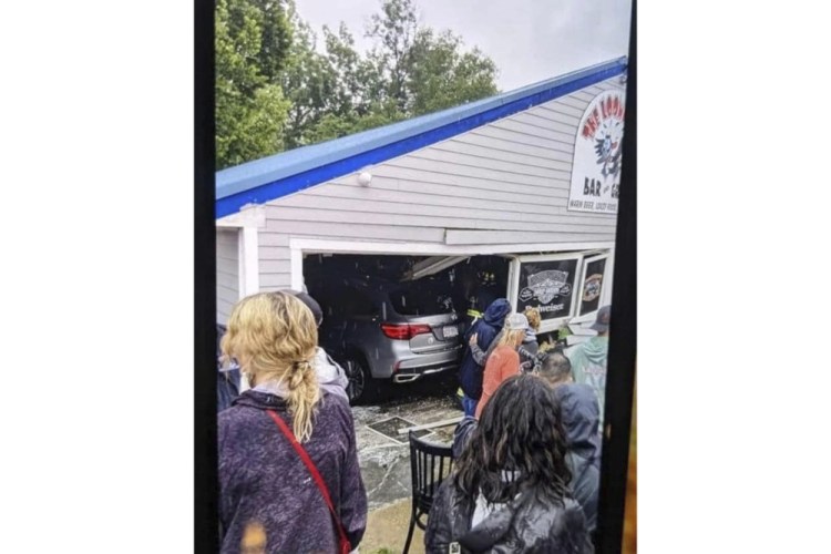 A vehicle sits inside a restaurant after crashing through the wall on Sunday in Laconia, N.H. The car struck the busy Looney Bin Bar & Grill and injured more than a dozen patrons inside, authorities said. Laconia Fire Department via AP