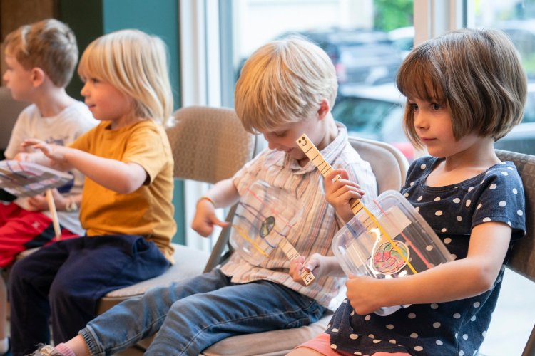 Little Roots Camp members, from right, Claire Bayes, 5 of Falmouth, Milo Bonacci, 4 of Yarmouth,  Bo Witherbee, 4 of Freeport and Miles Taylor, 5 of Falmouth play homemade ukuleles at 317 Main Community Music Center in Yarmouth. 